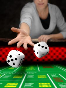woman throw dices on casino table